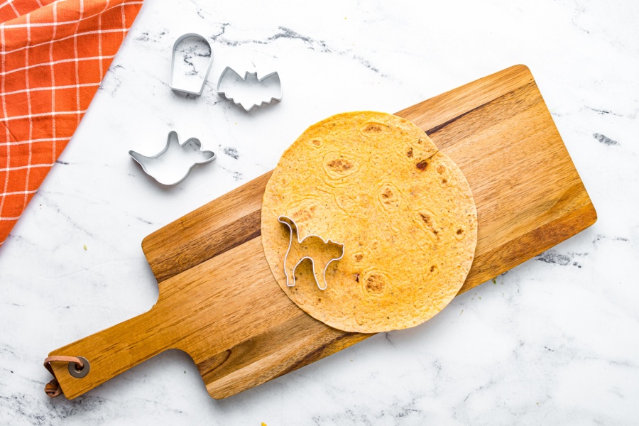 cutting tortilla with mini cookie cutters