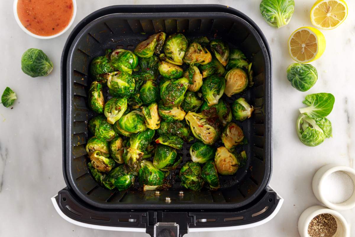 cooked Air Fryer Bang Bang Brussels Sprouts in air fryer basket