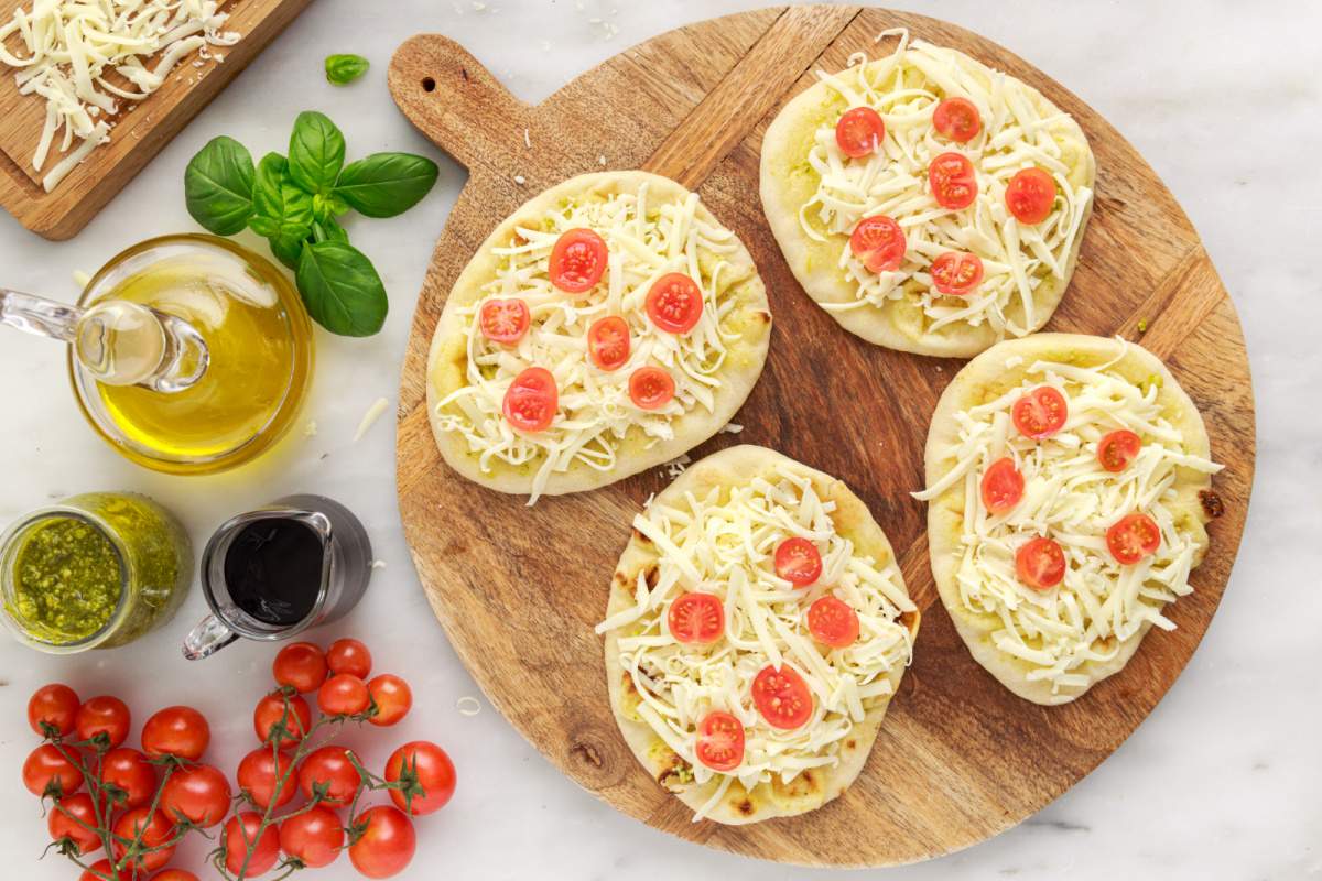 cheese and tomato added to top of naan