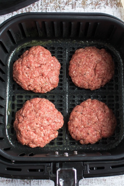 Air Fryer Cheeseburgers - hamburger patties in air fryer