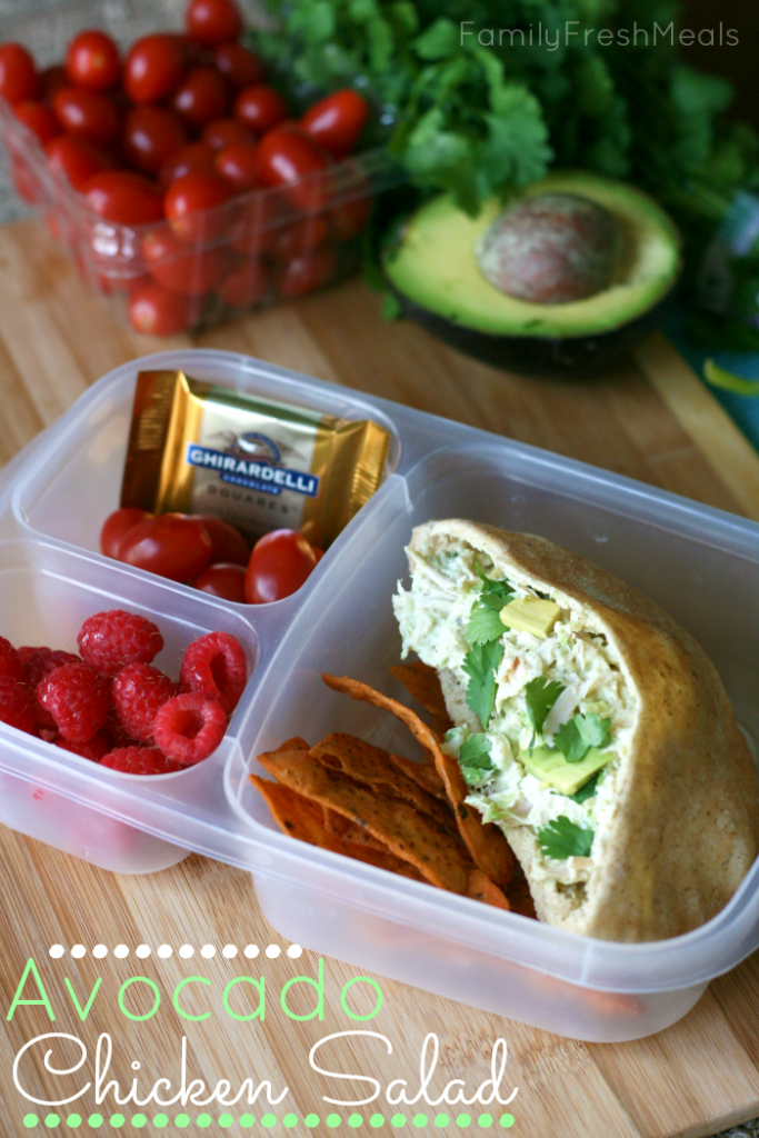 Avocado Chicken Salad in a pita, packed in a lunchbox with fruit and a piece of chocolate