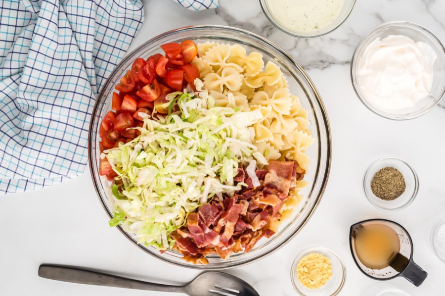 ingredients for blt pasta salad in mixing bowl