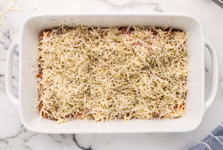 shredded cheese and Italian seasoning placed on top of ravioli