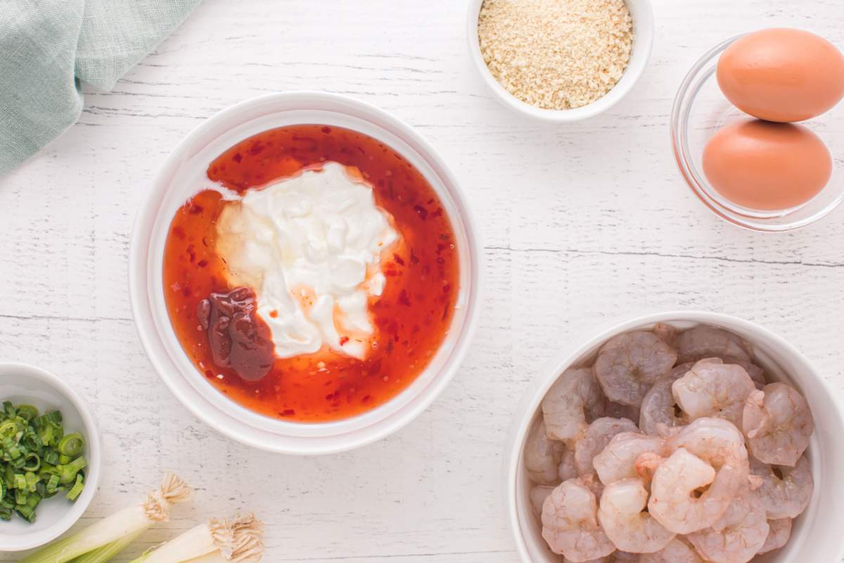 yogurt, sweet chili sauce, sriracha and honey in a bowl 