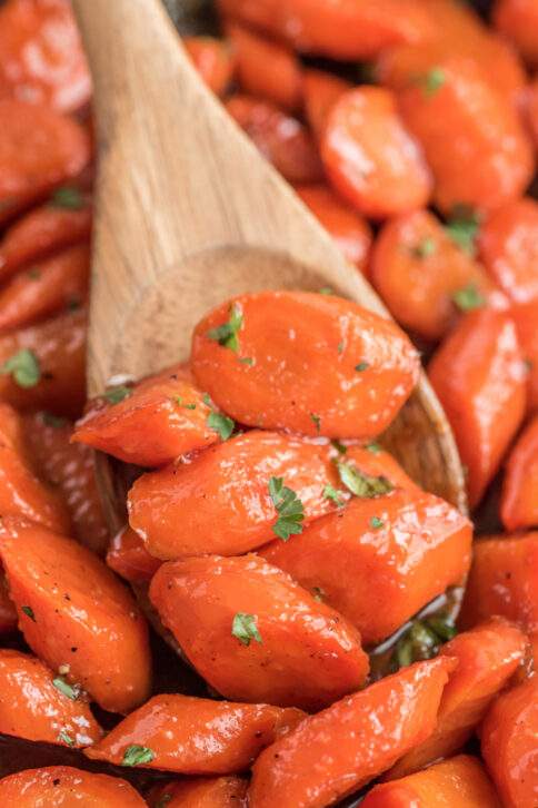 spoon scooping up some Brown Sugar Honey Glazed Carrots