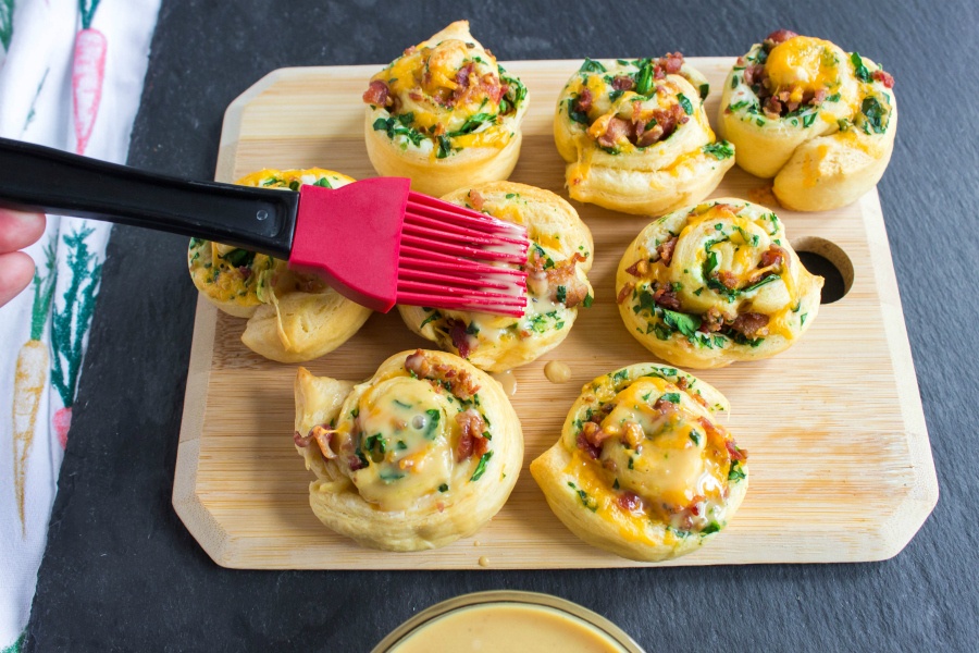 Cheesy Bacon Crescent Rolls Ups - brushing rolls with honey mustard