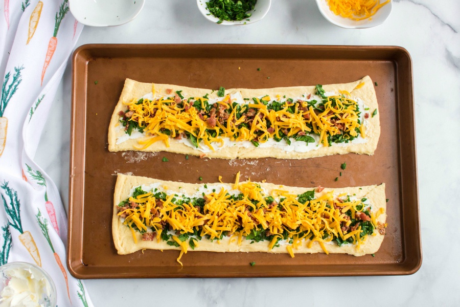 Cheesy Bacon Crescent Rolls Ups - shedded cheese, crumbled back and spinach add on to of dough