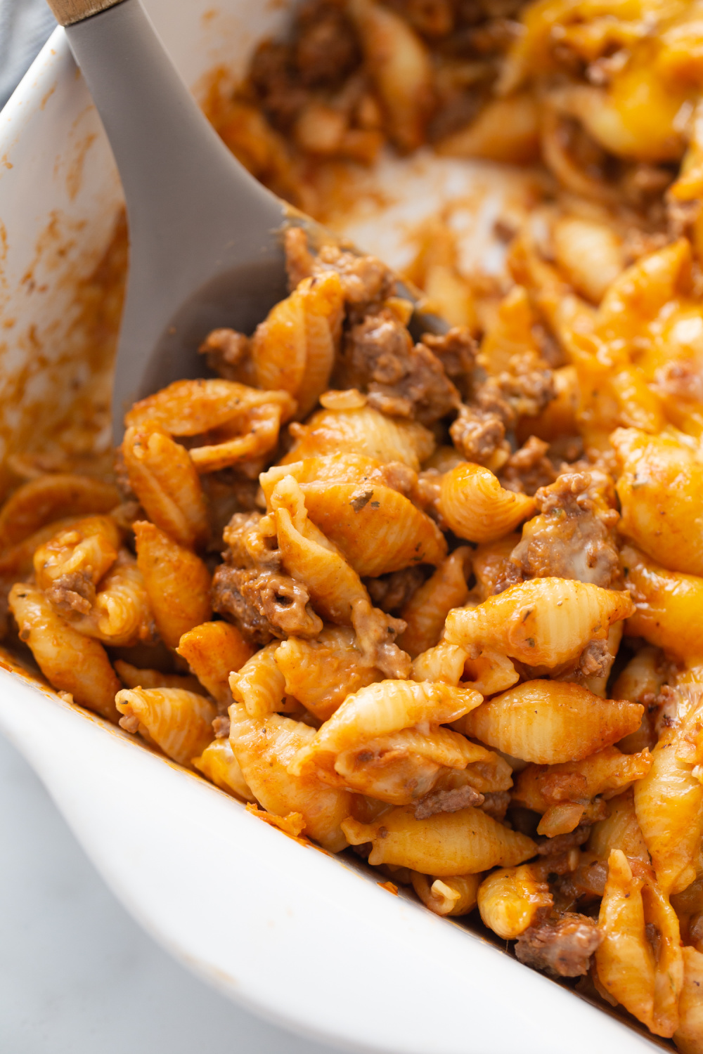 spoon scooping Cheesy Beef and Shells Casserole