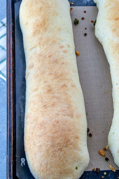 Cheesy Sausage Spinach Bread - baked sausage bread on baking sheet