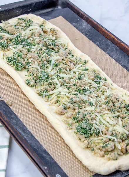 Cheesy Sausage Spinach Bread - dough rolled out and with sausage mixture spread on top