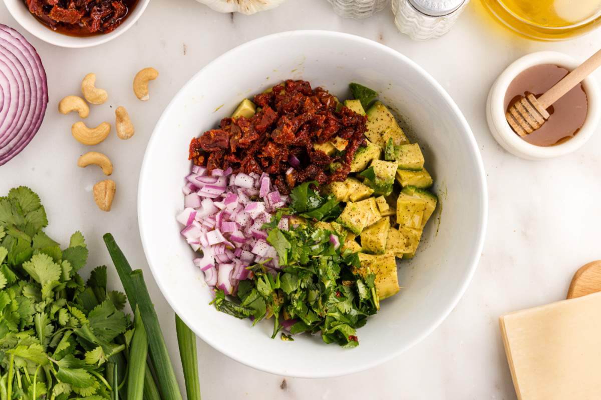 avocado, red onion, sundried tomatoes, chopped cilantro, and a pinch of salt and pepper in a bowl