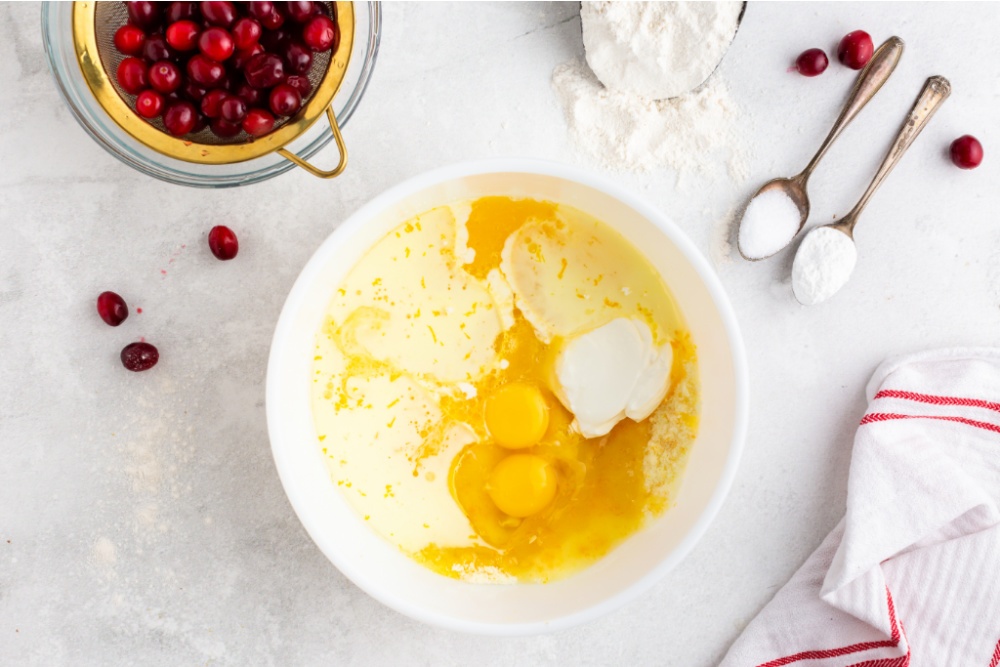 Ingredients for Cranberry Orange bread in a mixing bowl