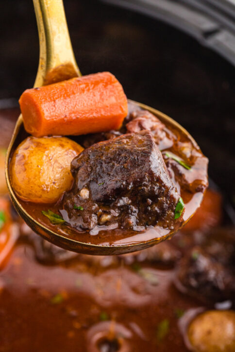 Ladle scooping up some Crockpot Beef Bourguignon