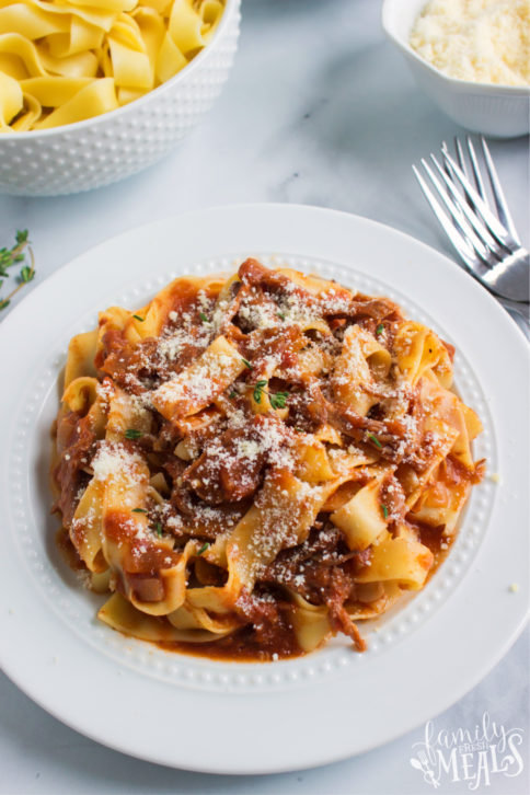 ragu served with noodles on a white plate