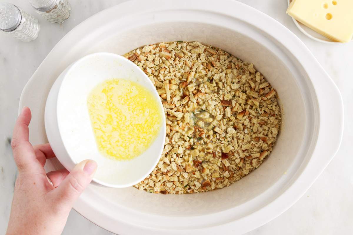 pouring butter over stuffing