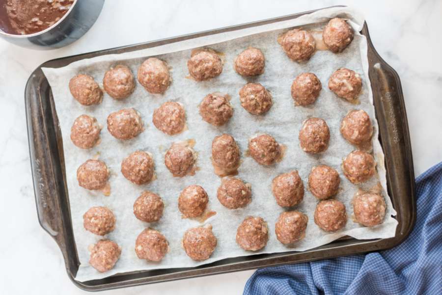 cooked meatballs on baking sheet