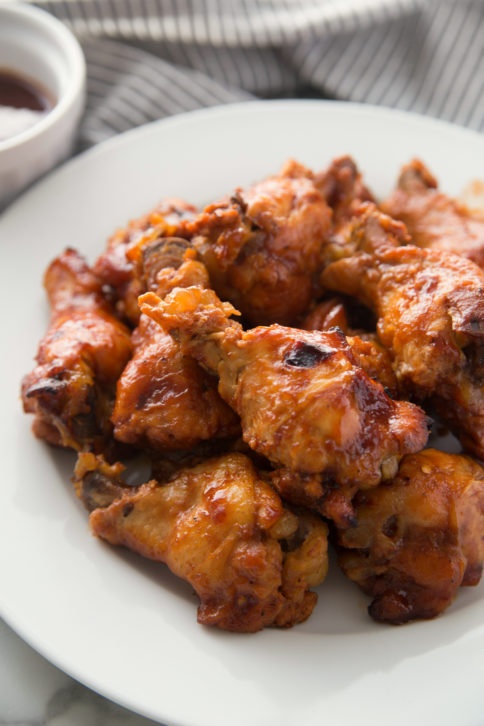 Chicken wings served on a white plate