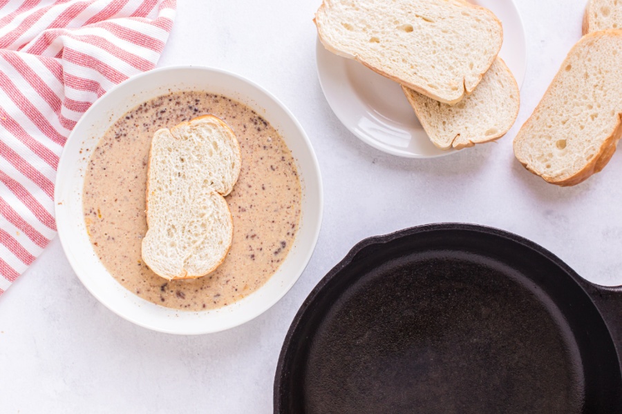 dipping bread into eggnog mixture