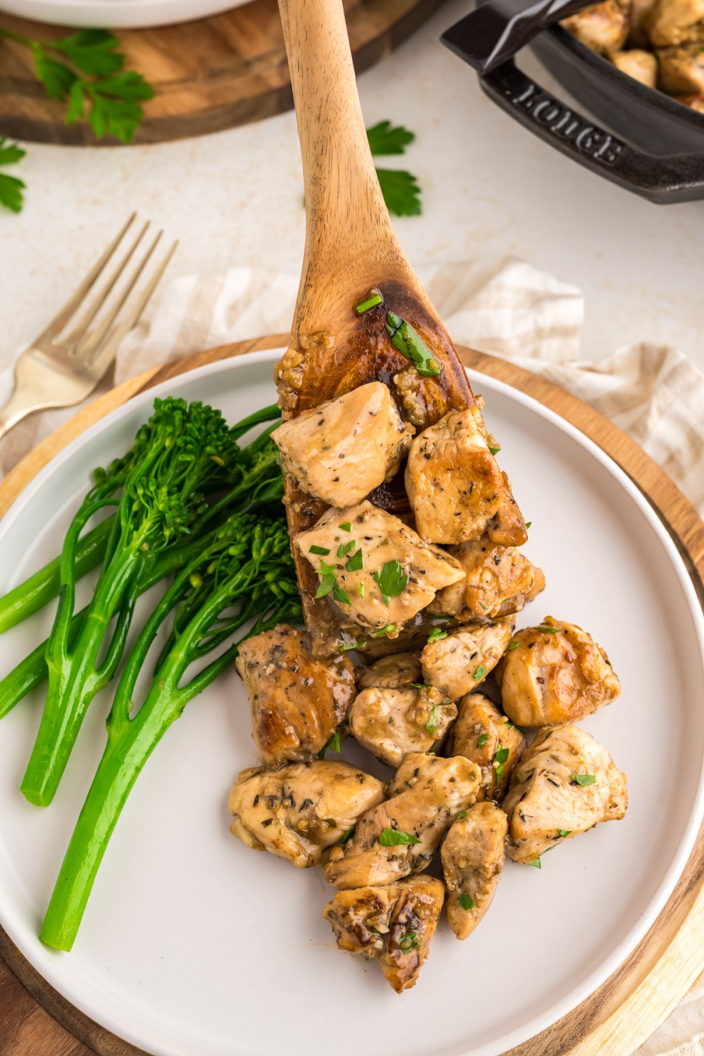 Garlic butter chicken bites on a plate with broccoli