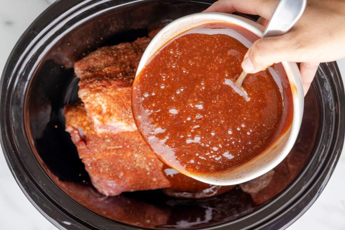 sauce being poured over ribs