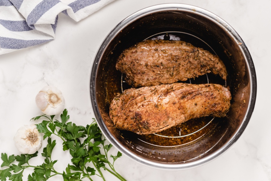 trivet placed in instant pot and pork placed on top