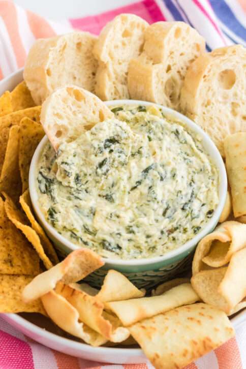 Instant Pot Spinach Artichoke Dip in a bowl with bread slices