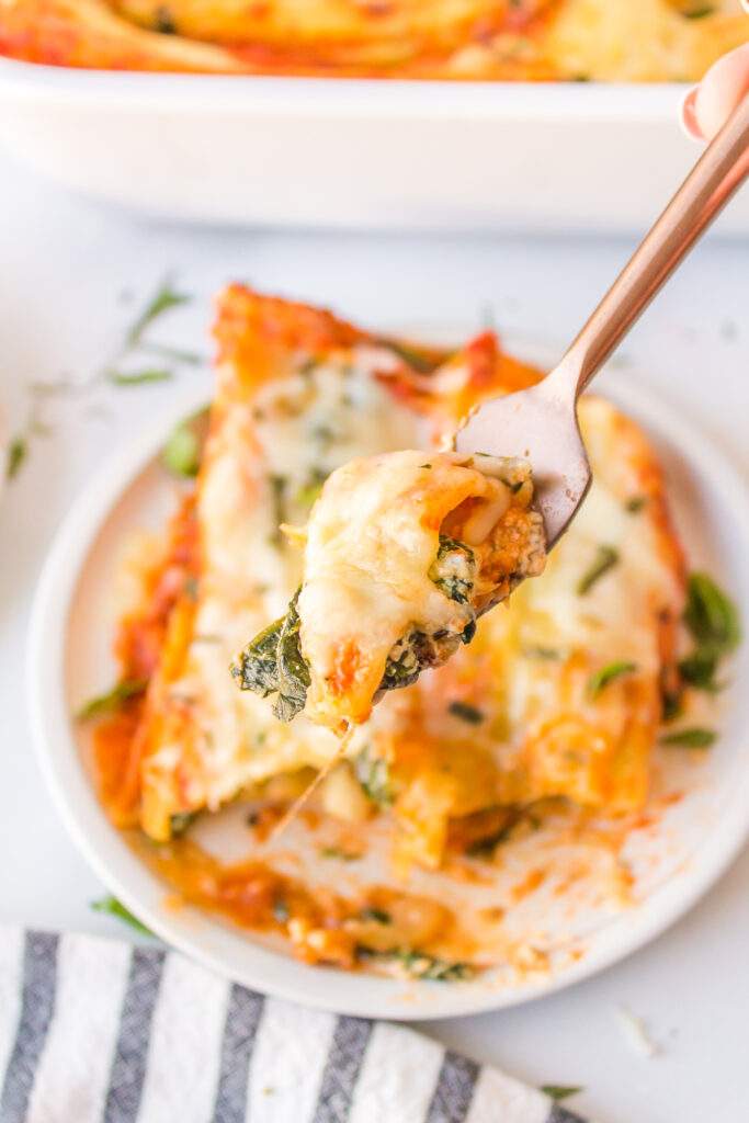 Italian Sausage Manicotti  on a plate with a fork