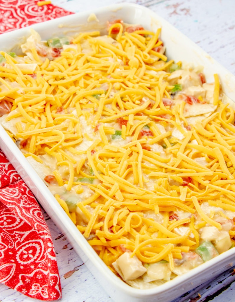 King Ranch Chicken Casserole in a baking dish topped with shredded cheese