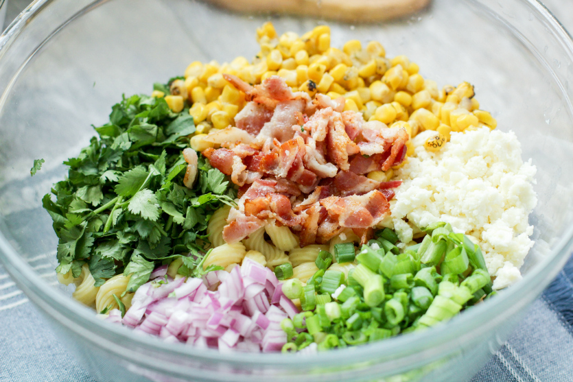 Mexican Street Corn Pasta Salad - salad ingredients in a large mixing bowl