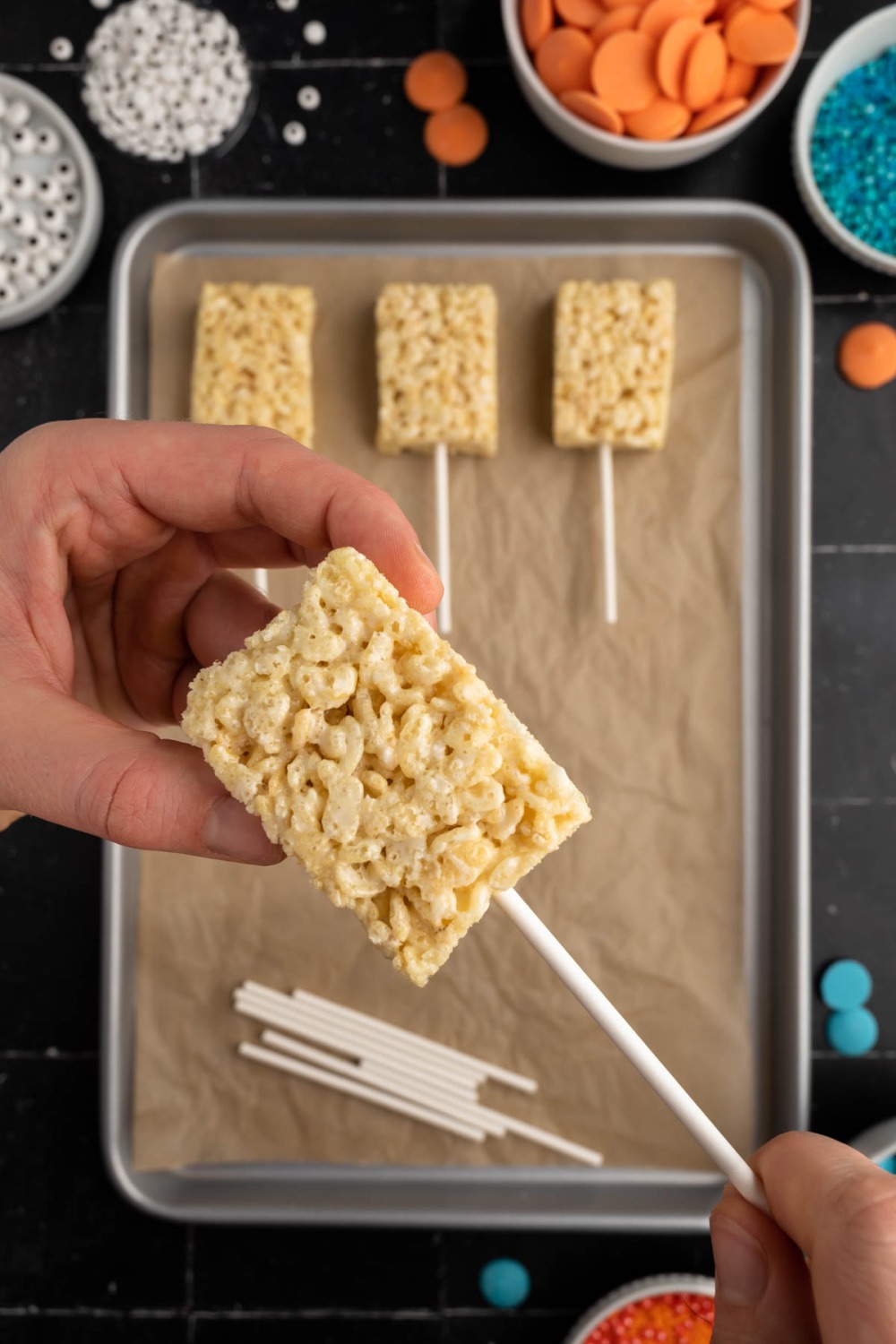 pushing sticks into Krispies treats