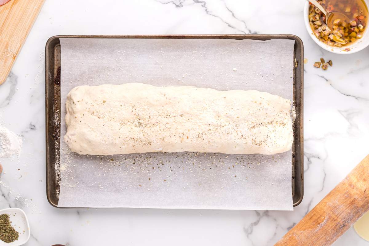 pizza dough rolled up on baking sheet