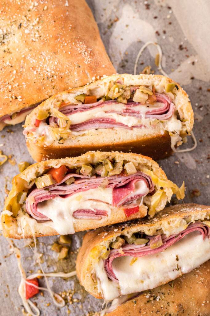 Muffuletta Garbage Bread sliced on a baking sheet