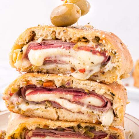 Muffuletta Garbage Bread stacked on a plate