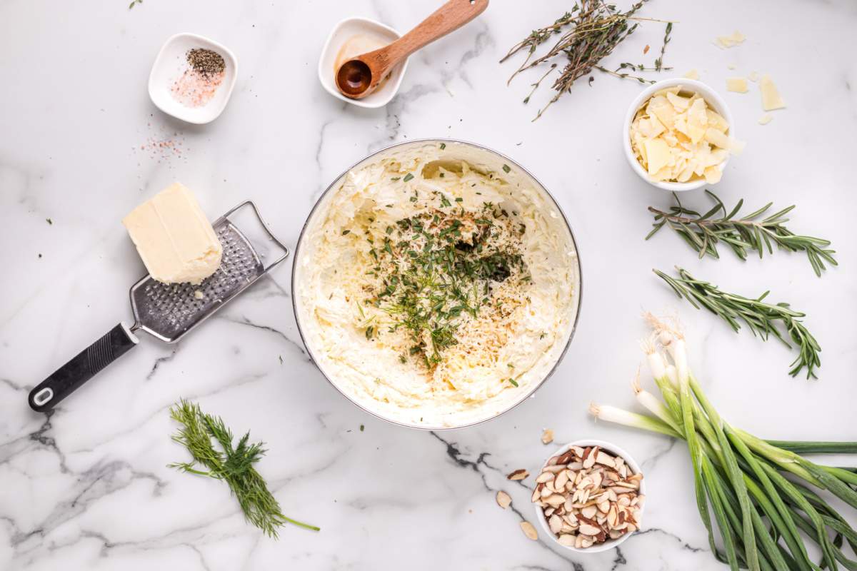 adding seasonings to whipped cream cheese