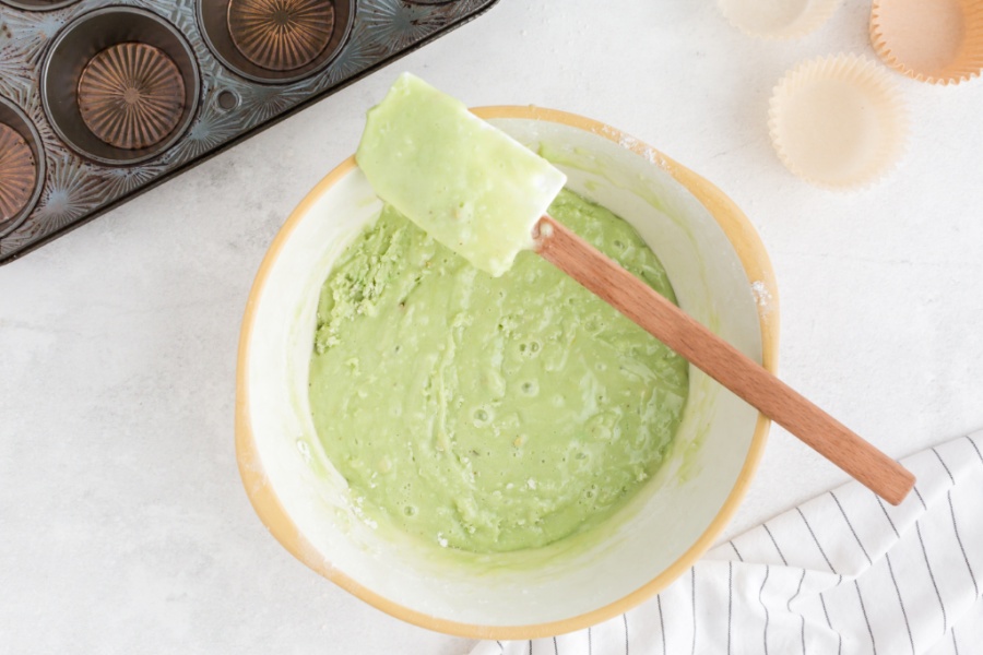 green muffin batter in a mixing bowl