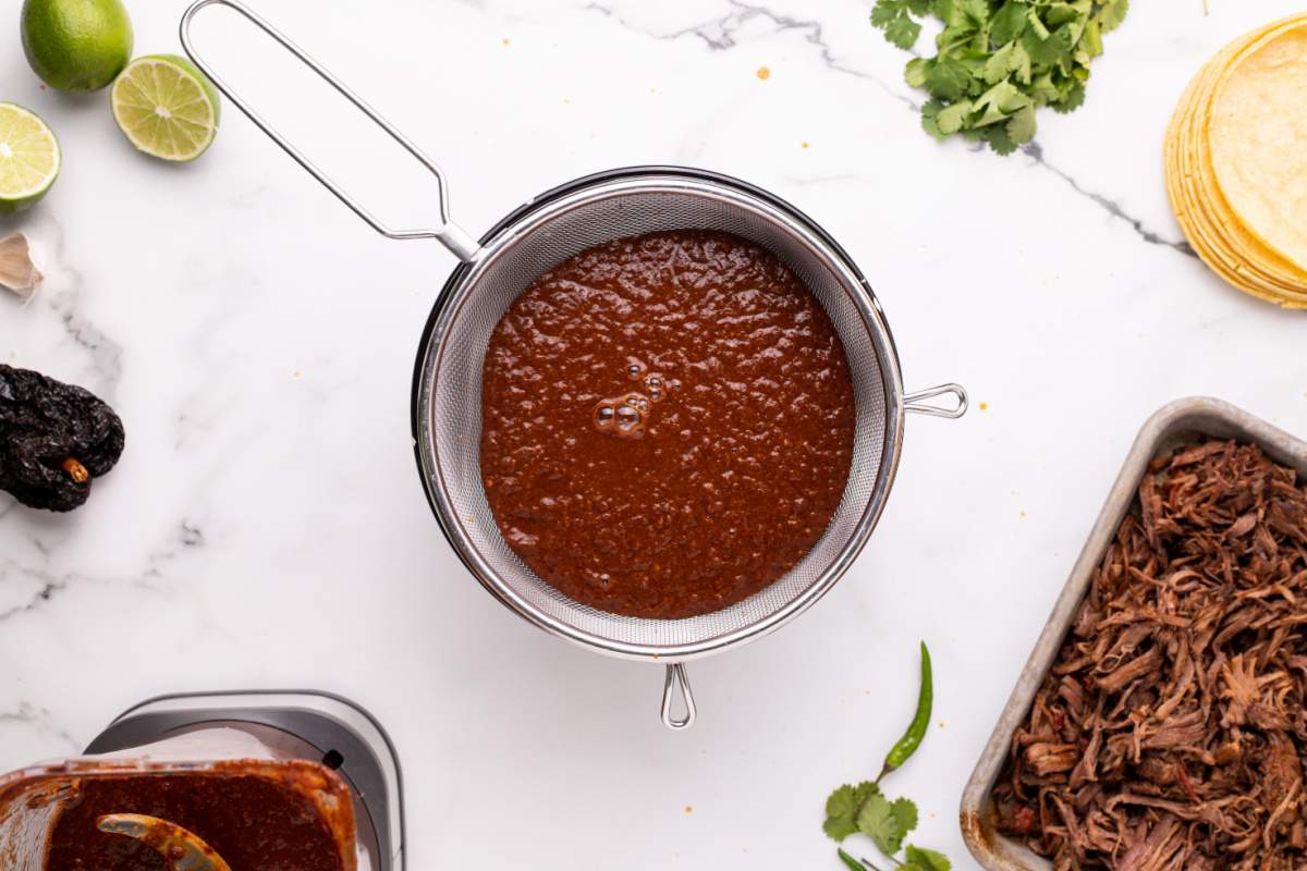 straining sauce in strainer