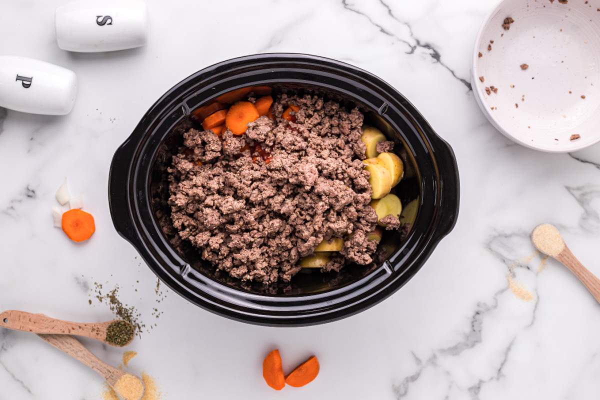 sliced carrots, diced potatoes, diced onions, Italian diced tomatoes and ground beef added to slow cooker