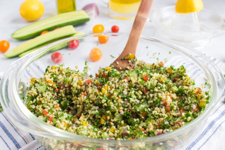 mixing Tabouli Salad in a bowl