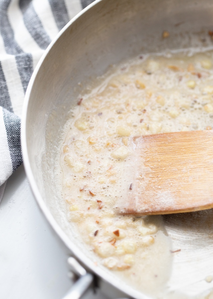 Melted better and onions cooking in a skillet