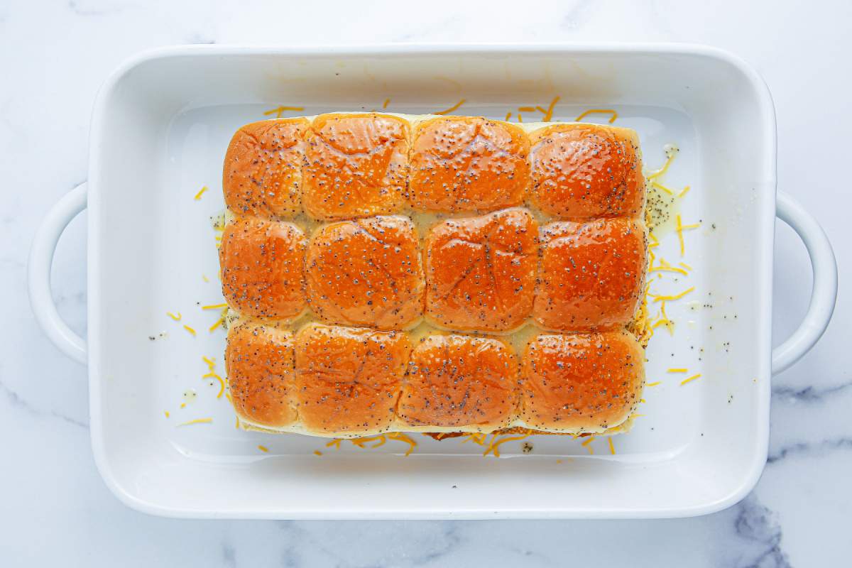 chili cheese dog sliders in a baking dish