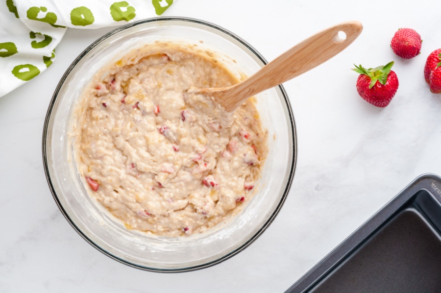 banana bread batter in a glass mixing bowl